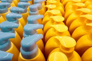Color plastic bottles with lids in a row. Background.