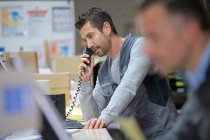businessman on phone at warehouse